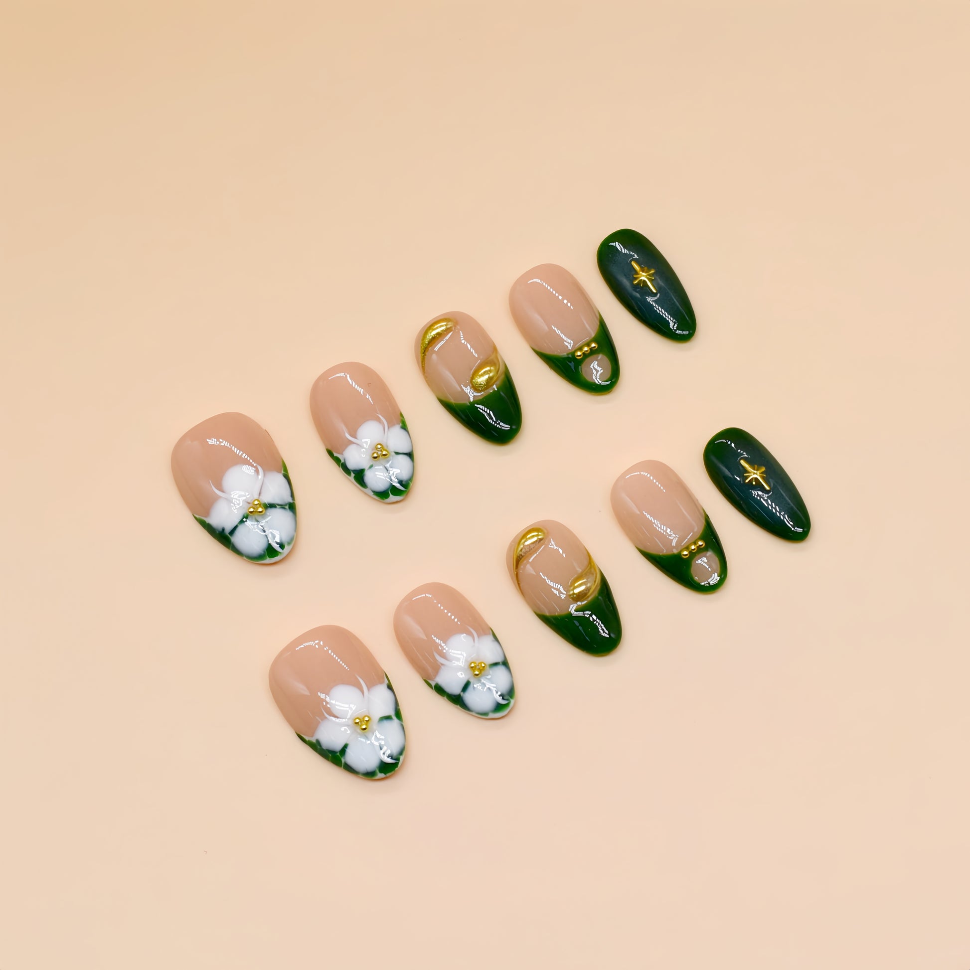 Press-on nails with emerald green French tips, white 3D blossoms, and gold swirl accents – Emerald Blossom.