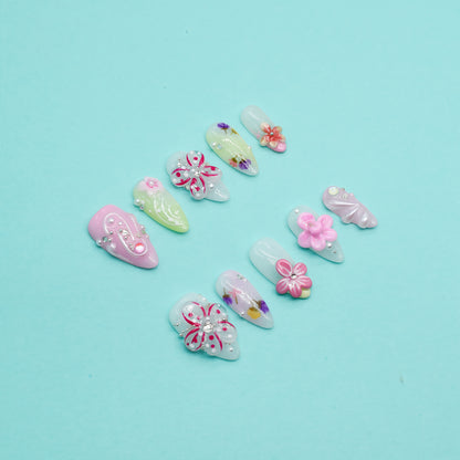 Floral Bliss long coffin press-on nails in pink and yellow gradient with 3D flowers, rhinestones, and floral art – Candy Bloom Collection
