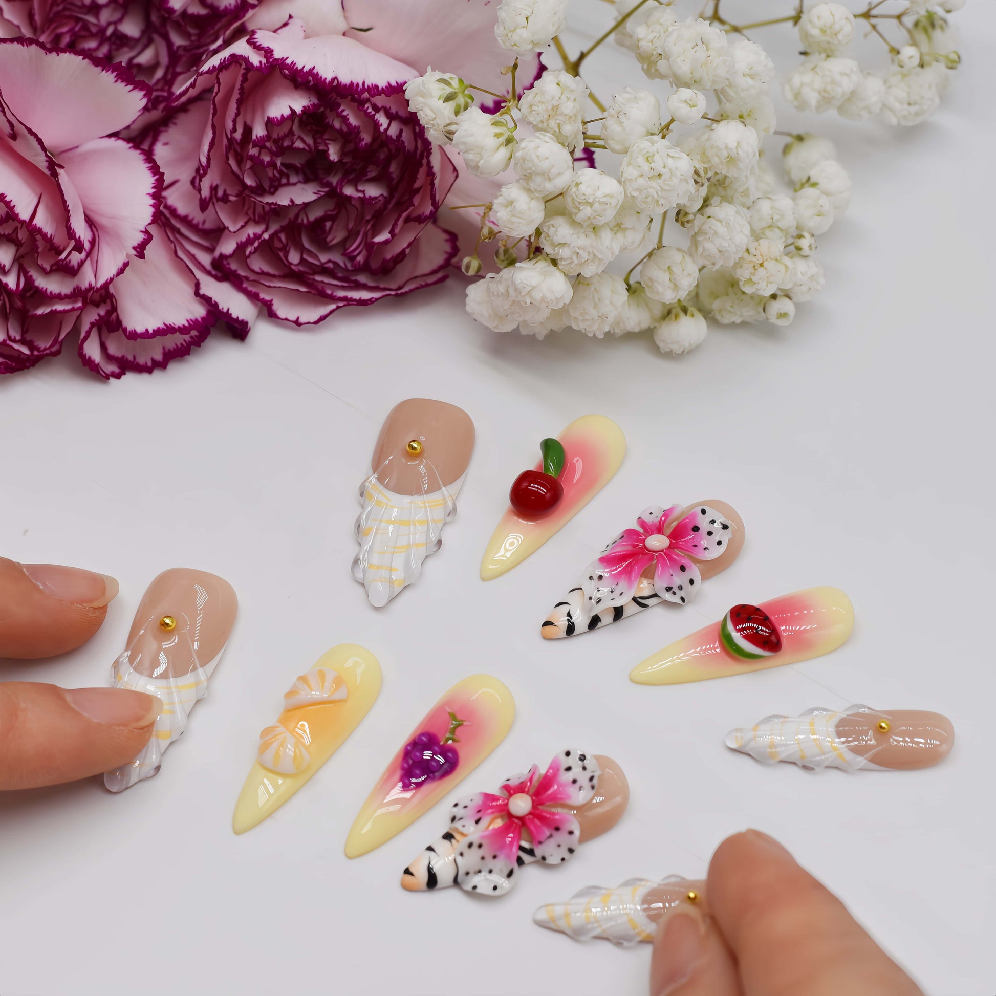 Handmade tropical fruit-inspired press-on nails with 3D floral art, ombré gradients, glossy finish, and transparent ribbon details