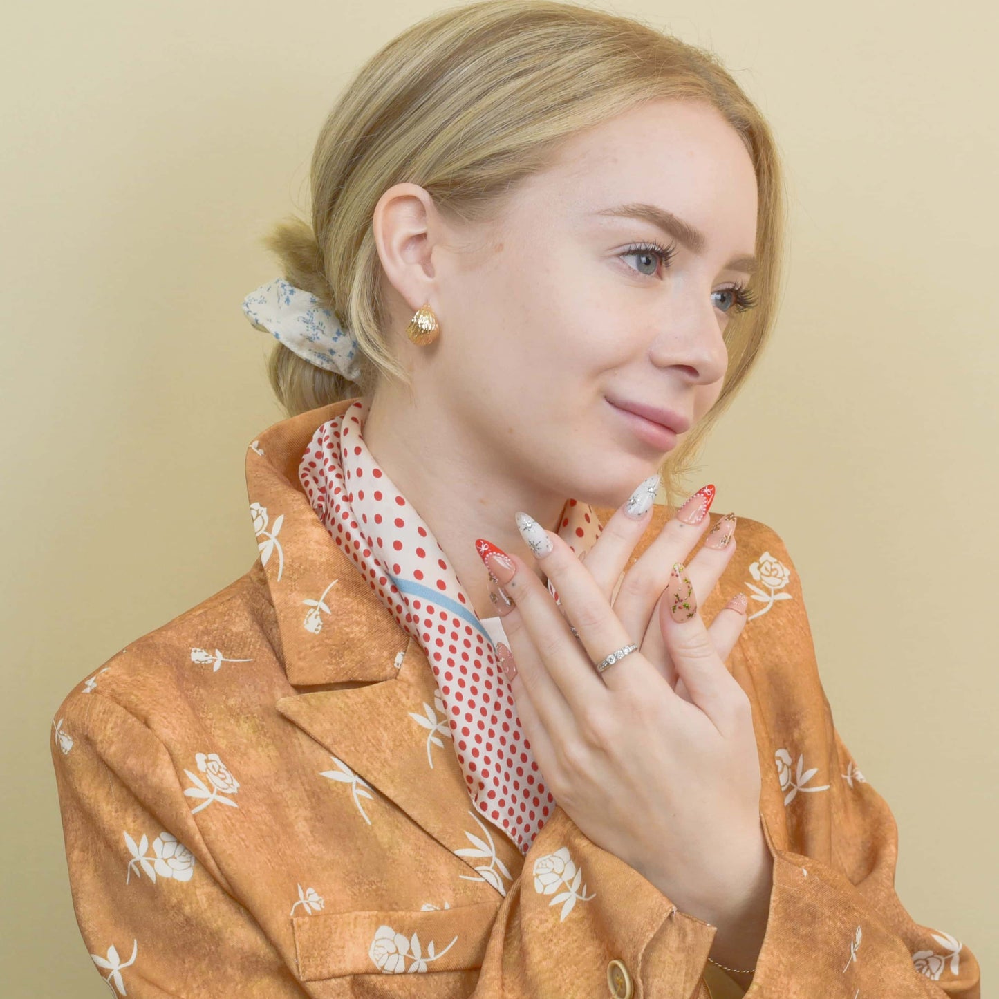 Gingerbread Joy press-on nails featuring gingerbread men, candy canes, holly leaves, and snowflakes on red and nude bases.