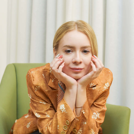 Gingerbread Joy press-on nails featuring gingerbread men, candy canes, holly leaves, and snowflakes on red and nude bases.