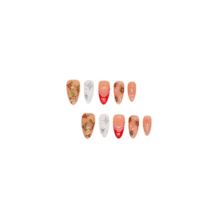 Gingerbread Joy press-on nails featuring gingerbread men, candy canes, holly leaves, and snowflakes on red and nude bases.