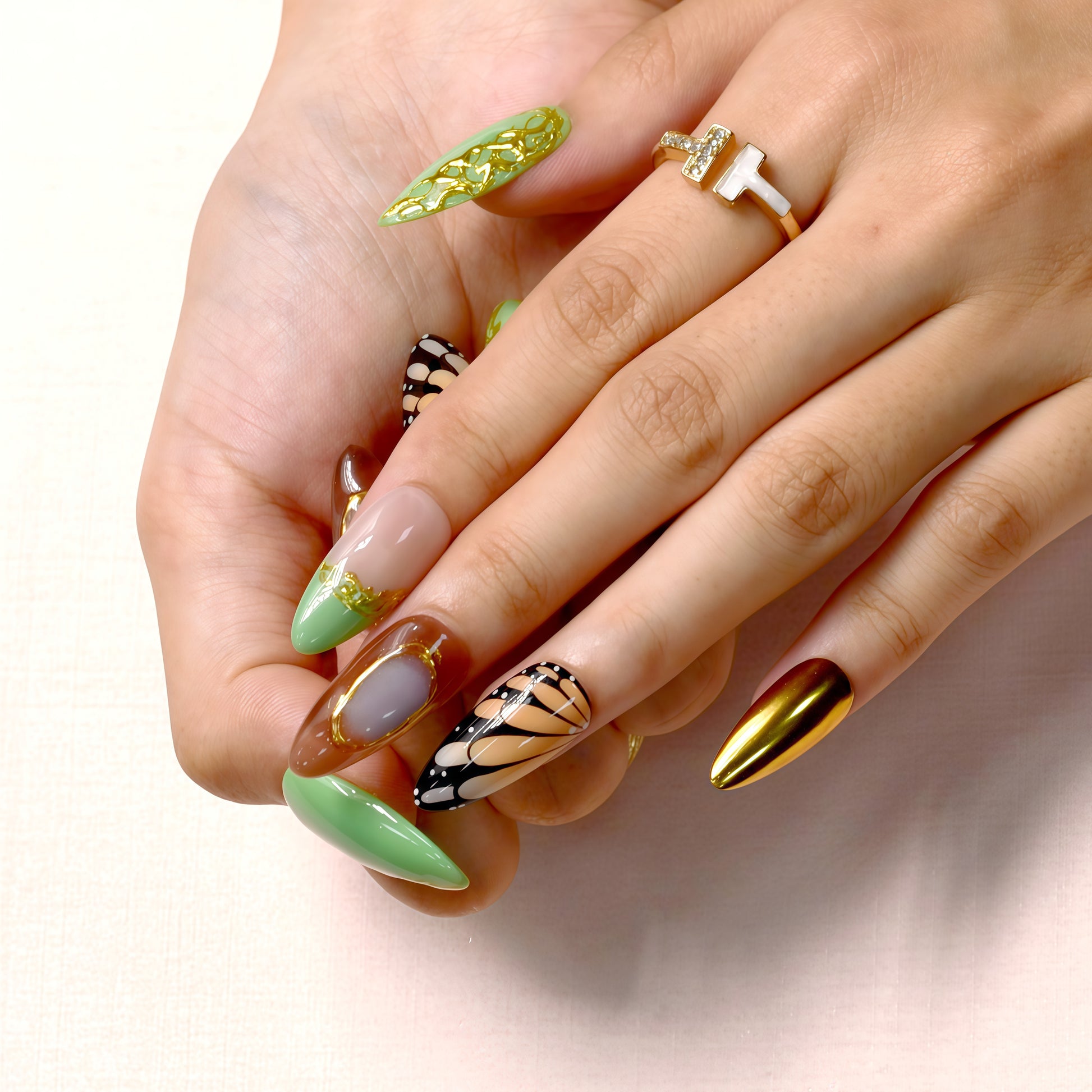 Golden Monarch handmade press-on nails by You Are Angel with butterfly wing designs, green vines, and gold chrome accent nails.