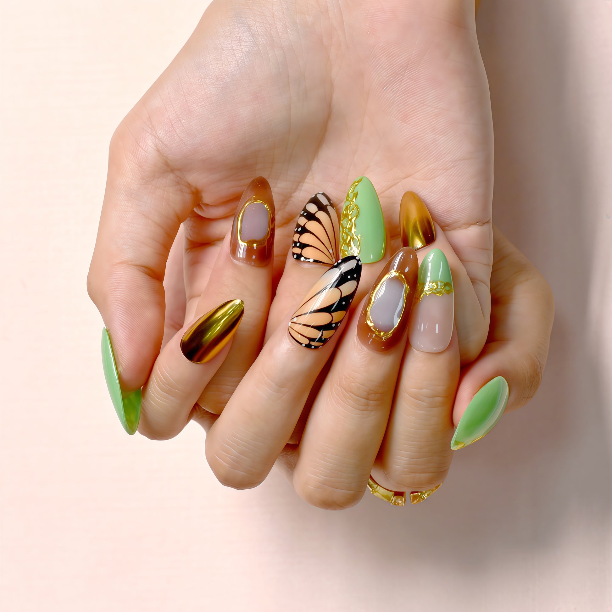 Golden Monarch handmade press-on nails by You Are Angel with butterfly wing designs, green vines, and gold chrome accent nails.