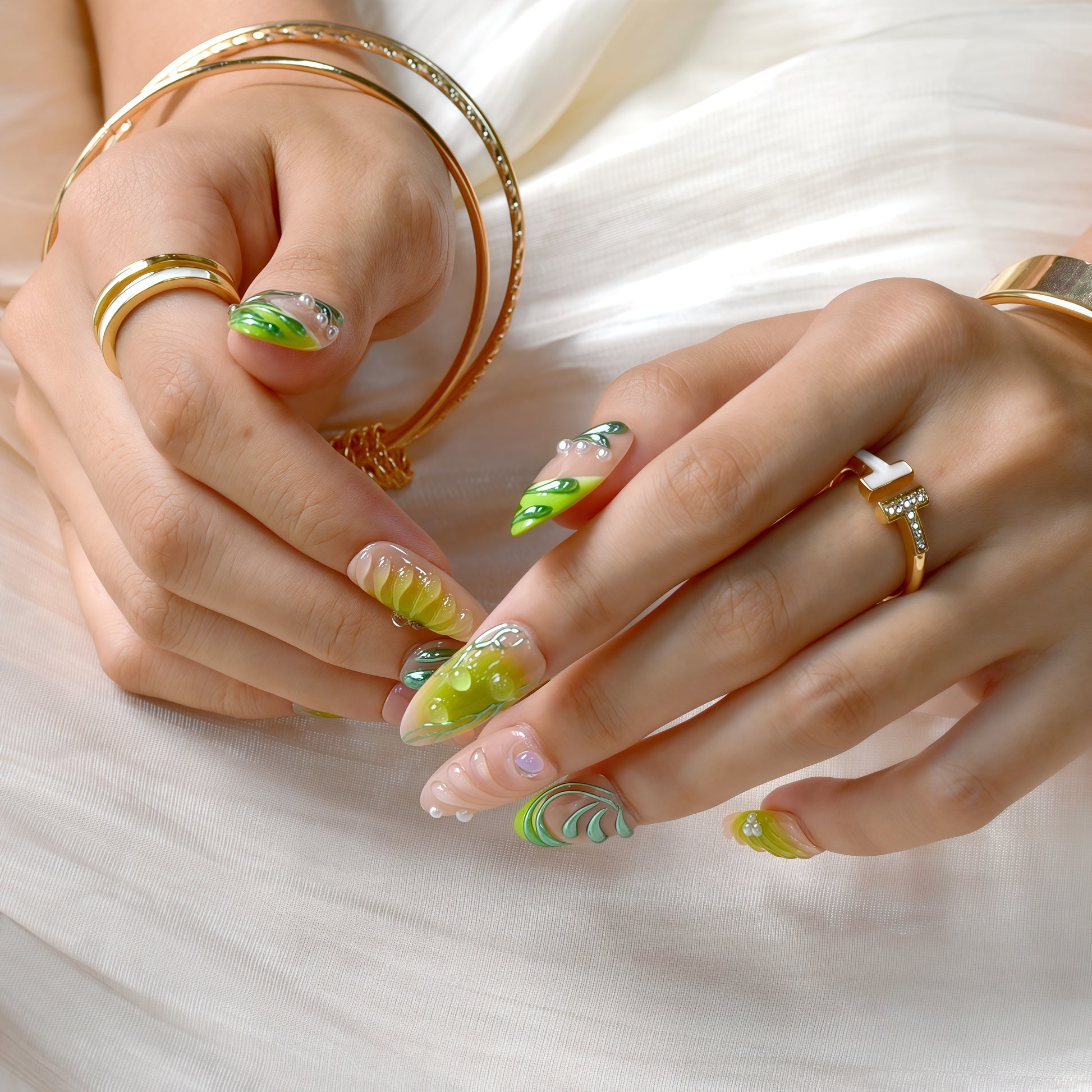 Close-up of hands with green and yellow nail design on a white background