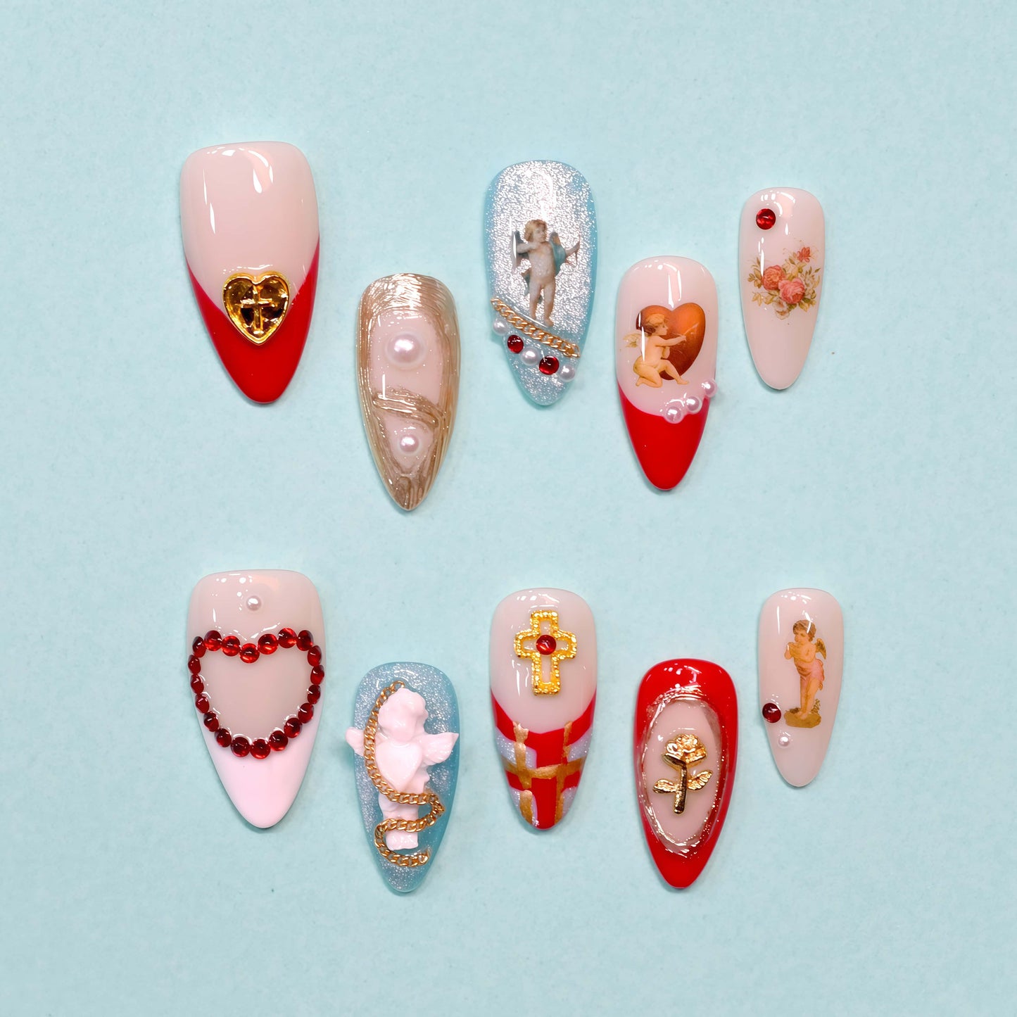 Heavenly Heartstrings press-on nails featuring angel and heart motifs, pearls, gold accents, and red French tips with celestial designs.