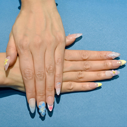 Tropical press on nails with nude base, bright 3D flowers in yellow, blue, and purple – Tropical Bloom Collection.