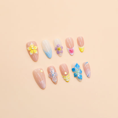 Tropical press on nails with nude base, bright 3D flowers in yellow, blue, and purple – Tropical Bloom Collection.