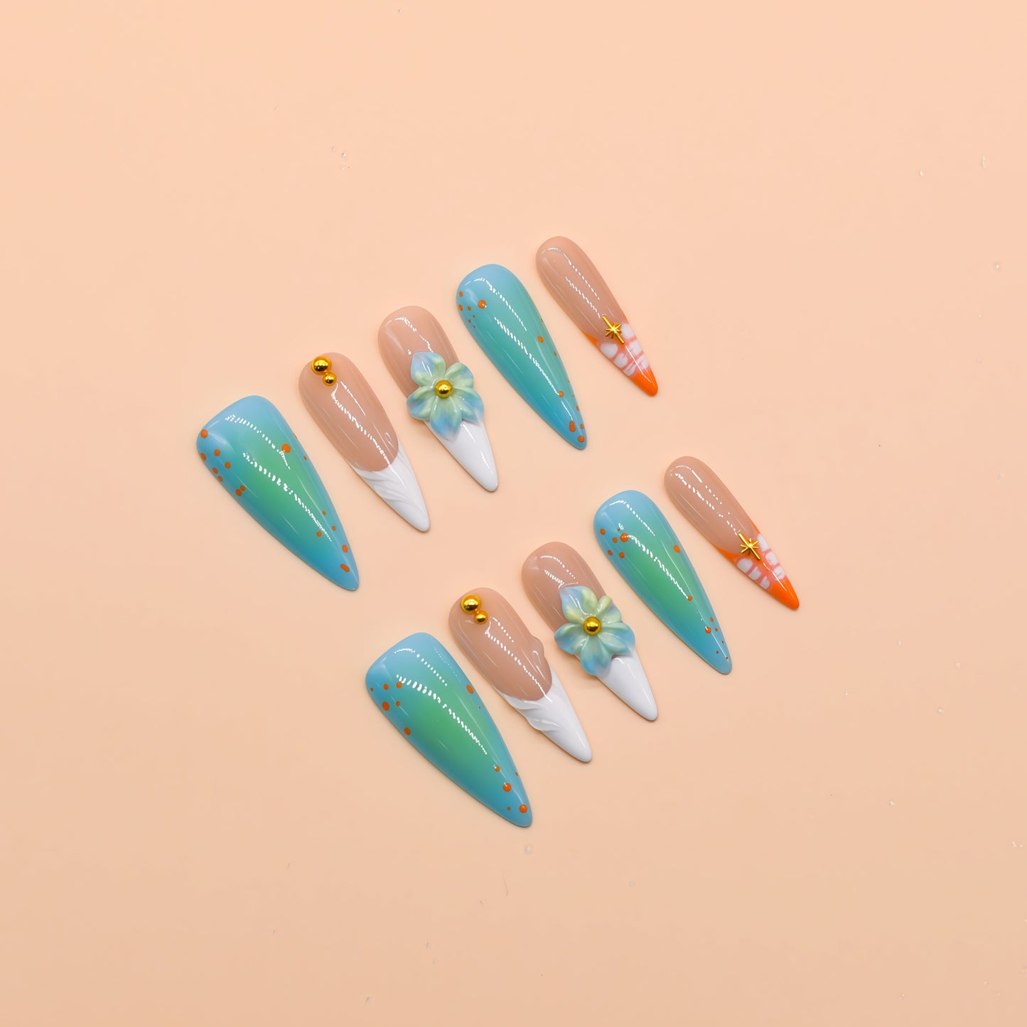 Tropical-themed stiletto press-on nails with aqua-blue gradient, 3D flowers, and orange coral accents – Island Bloom by You Are Angel.