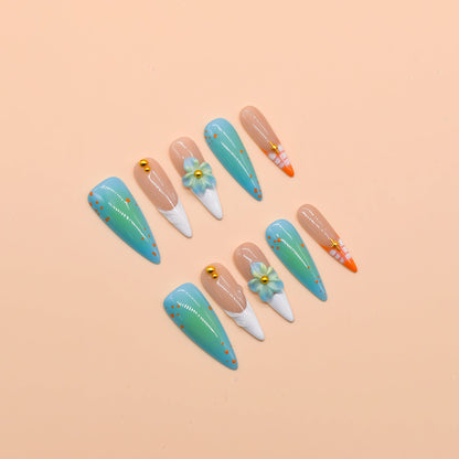 Tropical-themed stiletto press-on nails with aqua-blue gradient, 3D flowers, and orange coral accents – Island Bloom by You Are Angel.