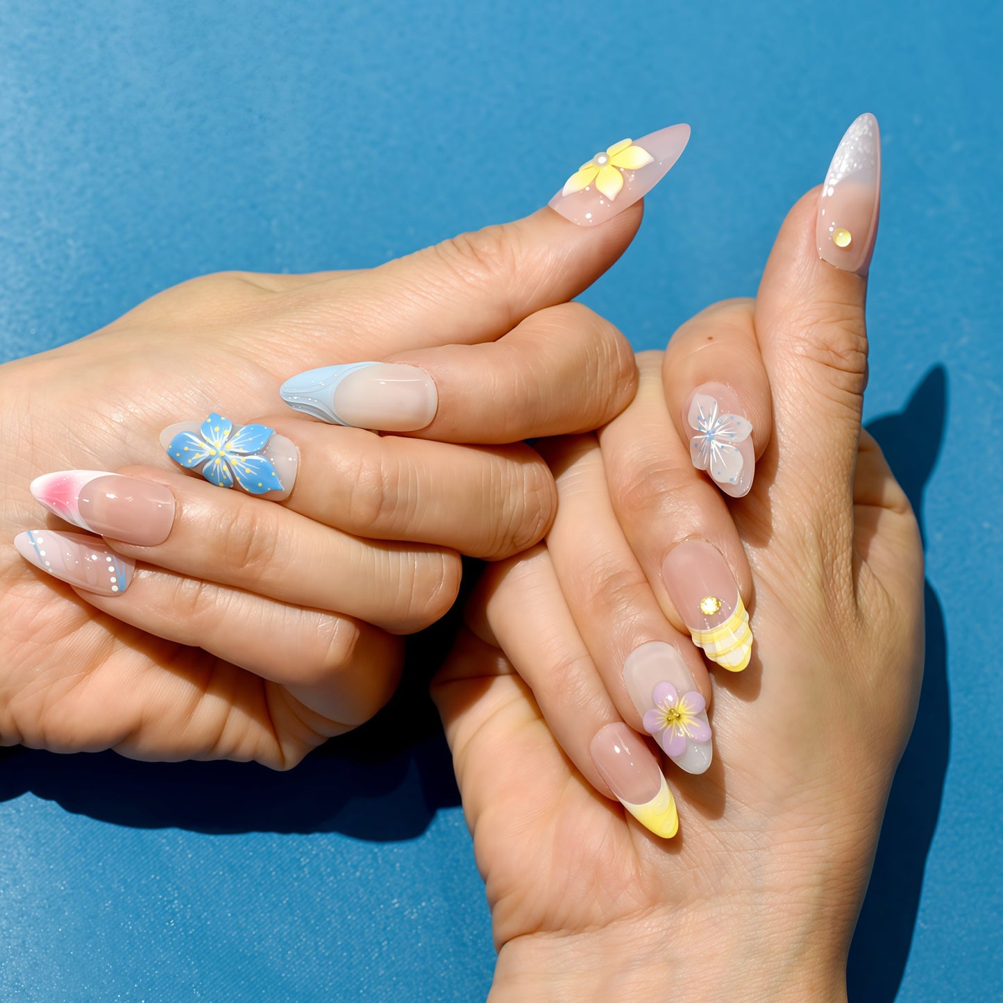 Tropical press on nails with nude base, bright 3D flowers in yellow, blue, and purple – Tropical Bloom Collection.