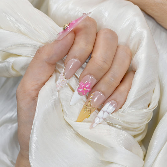 Long stiletto tropical press-on nails featuring vibrant pink and orange gradients, 3D starfish and gold seashell accents – Island Glow nail set.