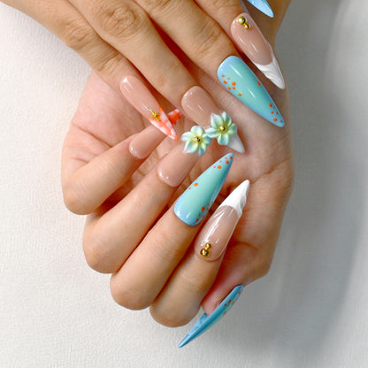 Tropical-themed stiletto press-on nails with aqua-blue gradient, 3D flowers, and orange coral accents – Island Bloom by You Are Angel.
