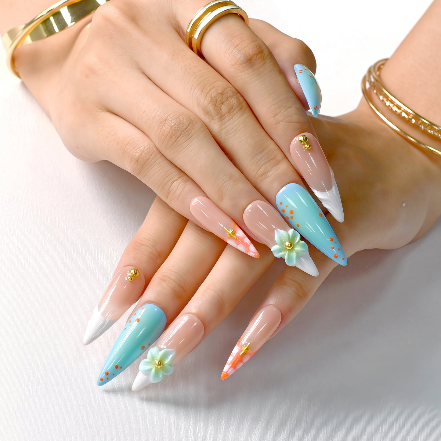 Tropical-themed stiletto press-on nails with aqua-blue gradient, 3D flowers, and orange coral accents – Island Bloom by You Are Angel.
