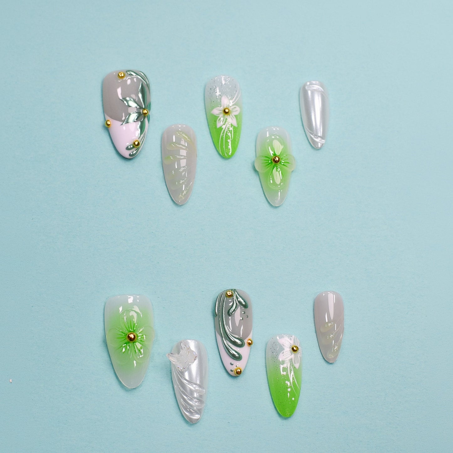 Green and white floral press-on nails with 3D blossoms, leaf detailing, and gold embellishments – handmade by You Are Angel.