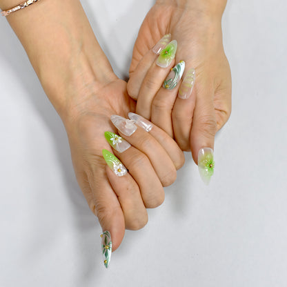 Green and white floral press-on nails with 3D blossoms, leaf detailing, and gold embellishments – handmade by You Are Angel.
