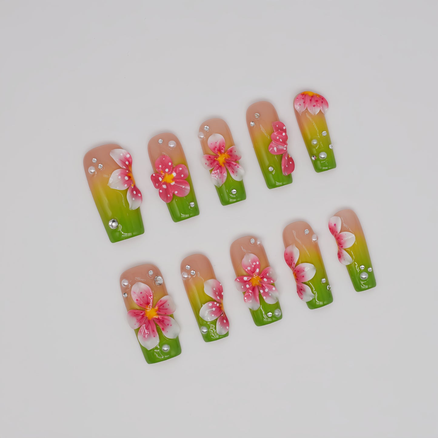 Handmade lime green floral press-on nails with 3D pink flowers and rhinestone accents on long square glossy nails