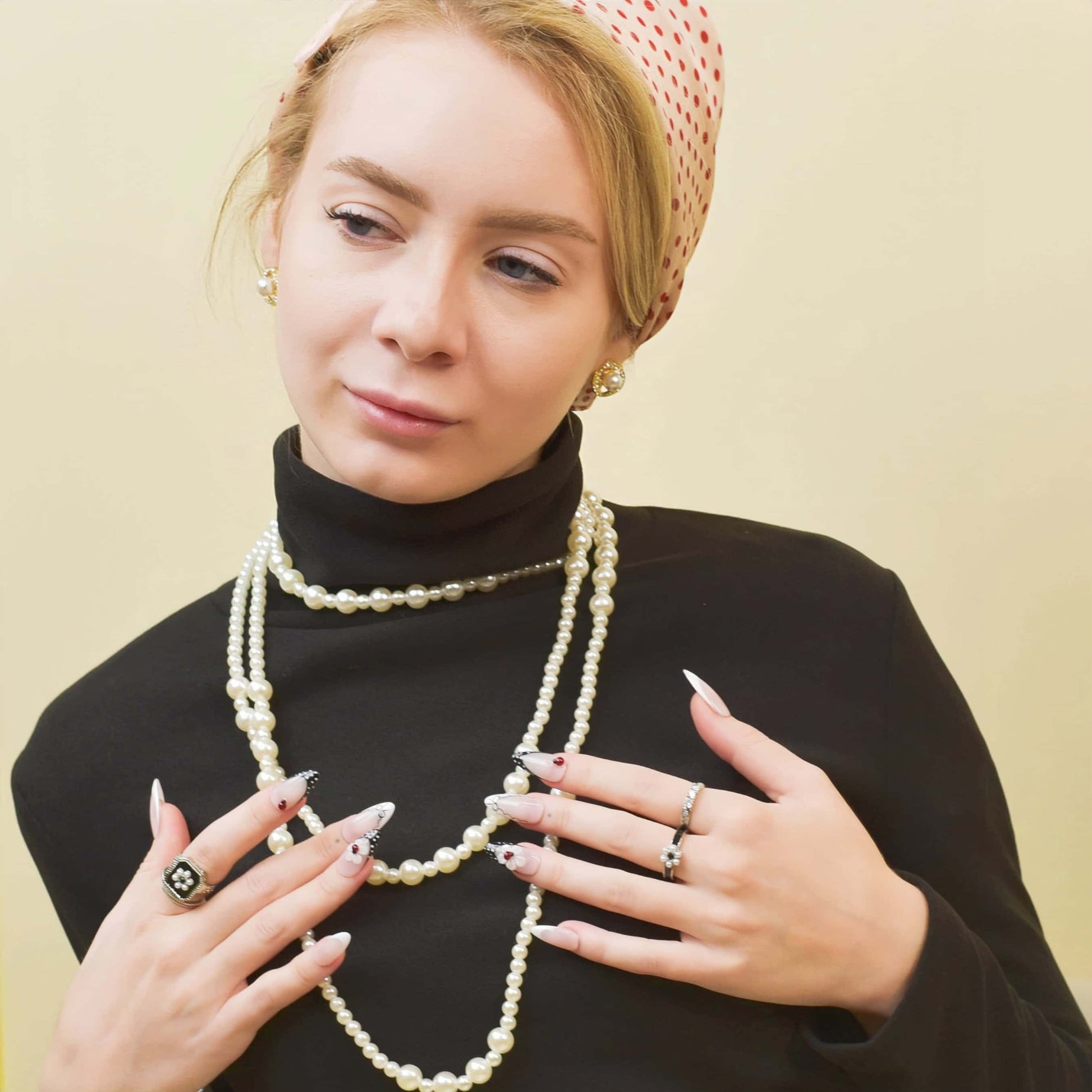 Midnight Lace press-on nails with nude base, black lace tips, red accents, and delicate 3D bows for a romantic elegant look.