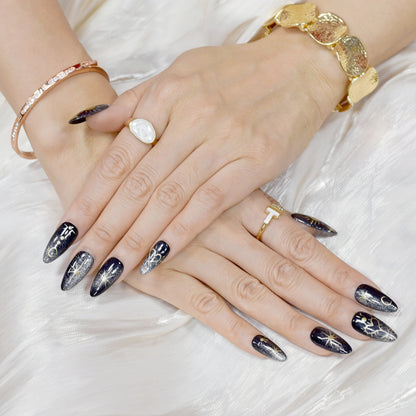 Moonlight Ritual handmade press-on nails by You Are Angel featuring black base with gold celestial art including moons, stars, and hearts.