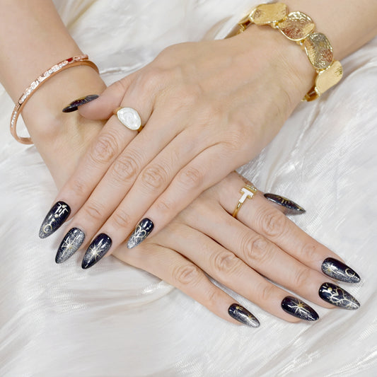 Moonlight Ritual handmade press-on nails by You Are Angel featuring black base with gold celestial art including moons, stars, and hearts.