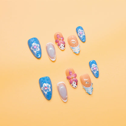 Ocean Bloom long coffin press-on nails in bold blue and pink with 3D butterfly, floral art, and gemstone details – Tropical Bloom Collection.