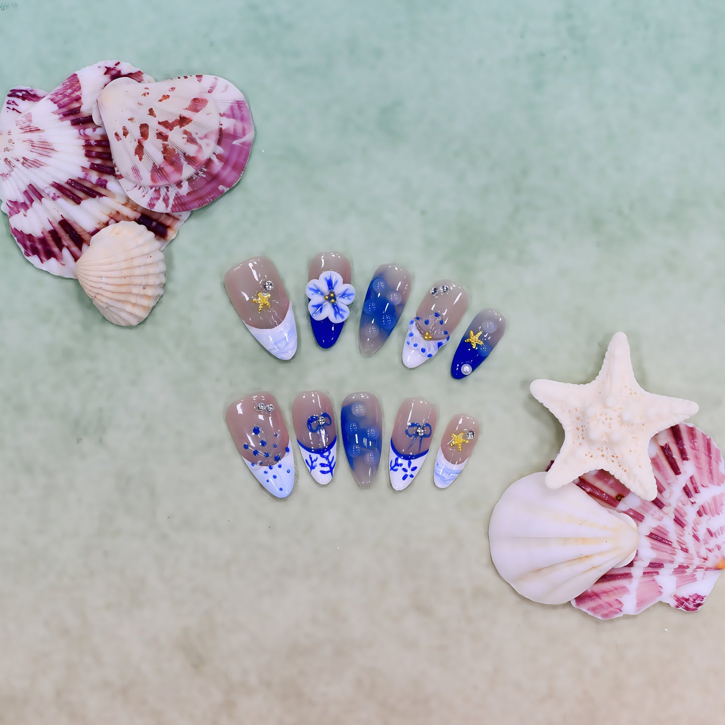 Handmade medium-length coffin press-on nails in ocean blue tones with 3D floral, coral, and starfish designs – Ocean Whimsy set.