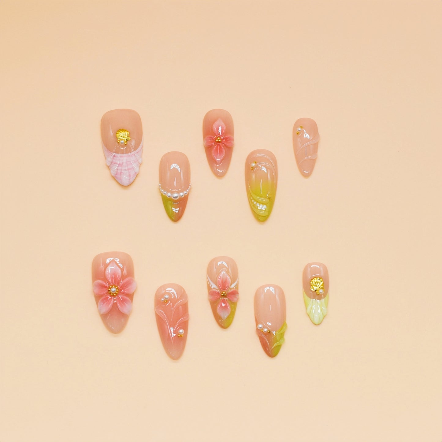 Peach Blossom Whispers press-on nails with soft gradient pink tones, 3D blossoms, pearl accents, and handmade floral designs.