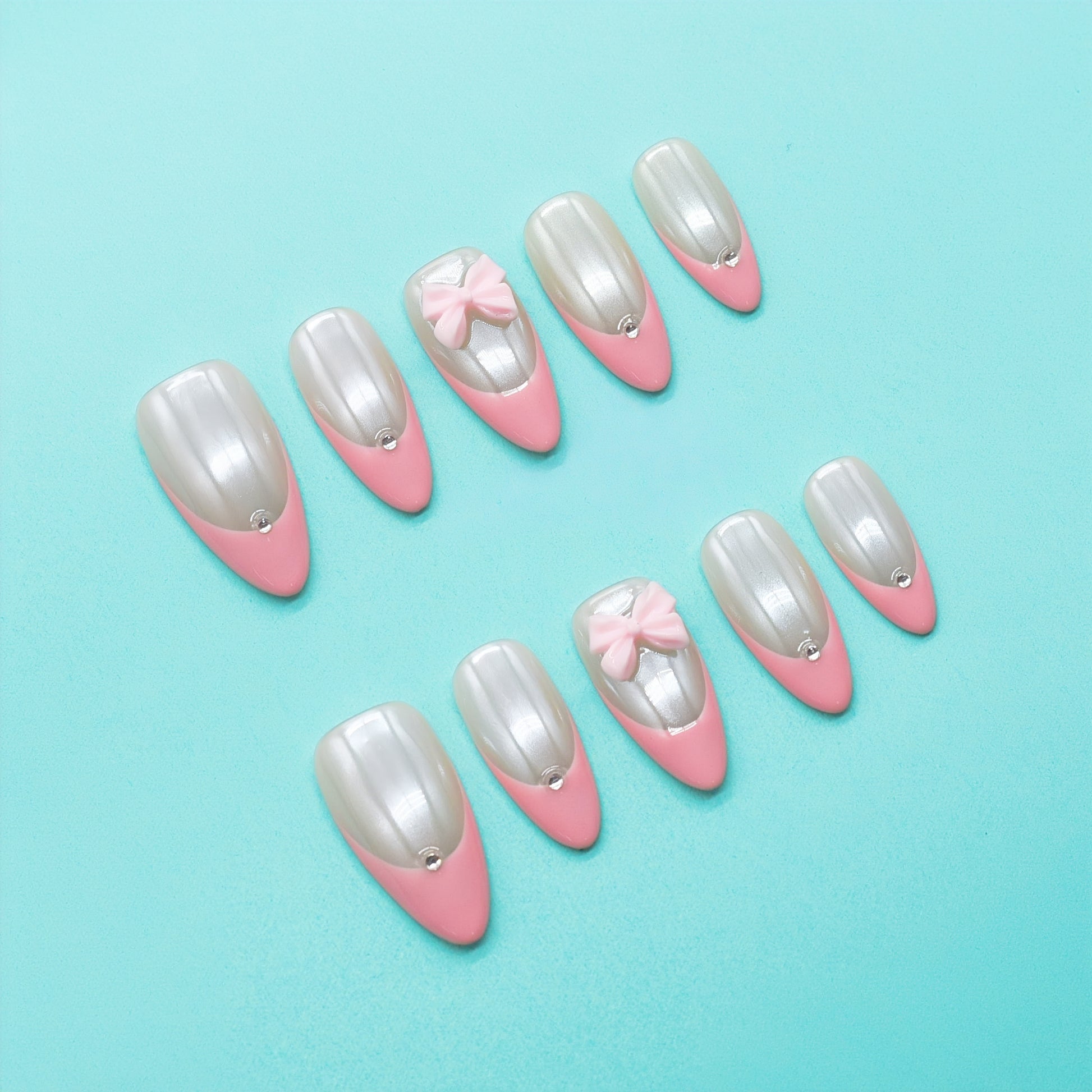 Soft pearl pink French press on nails with glossy finish, 3D bow charms, and rhinestone accents – Blushing Bows Collection.