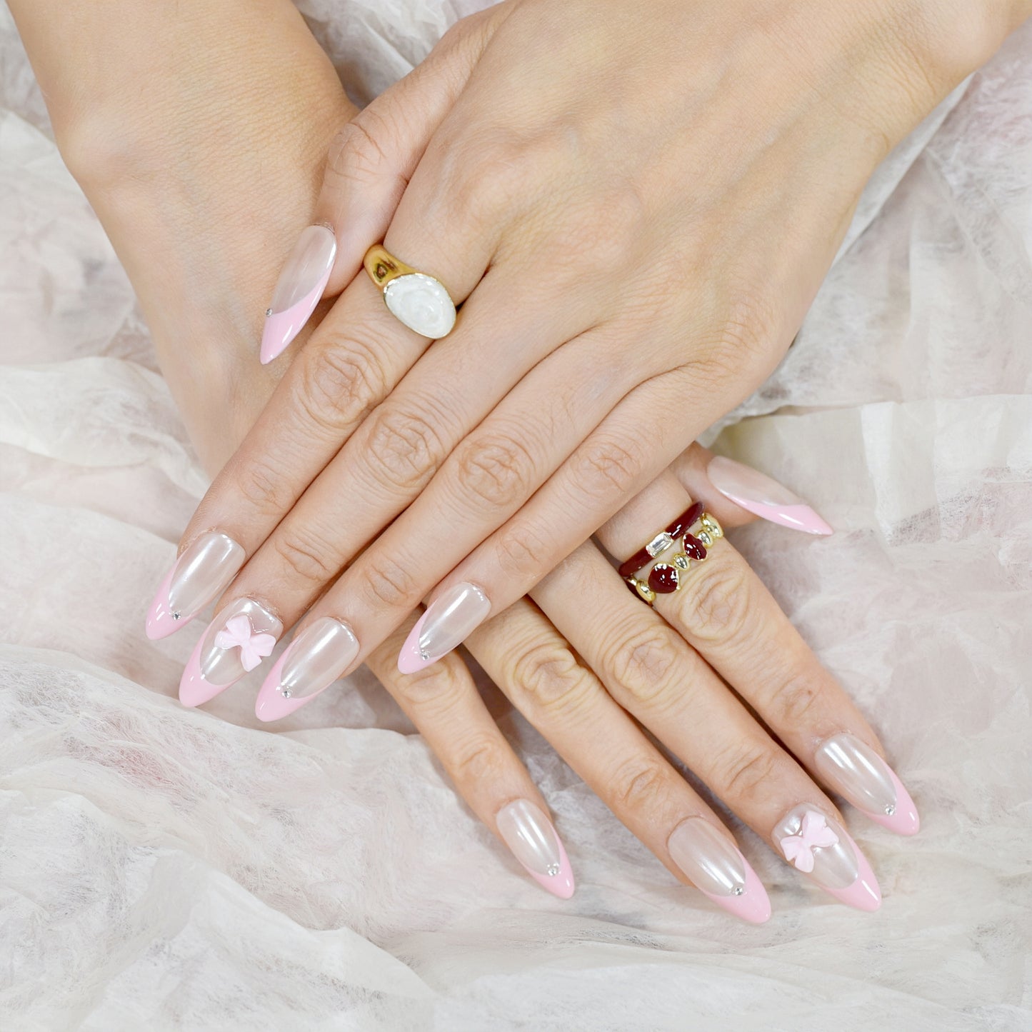 Soft pearl pink French press on nails with glossy finish, 3D bow charms, and rhinestone accents – Blushing Bows Collection.