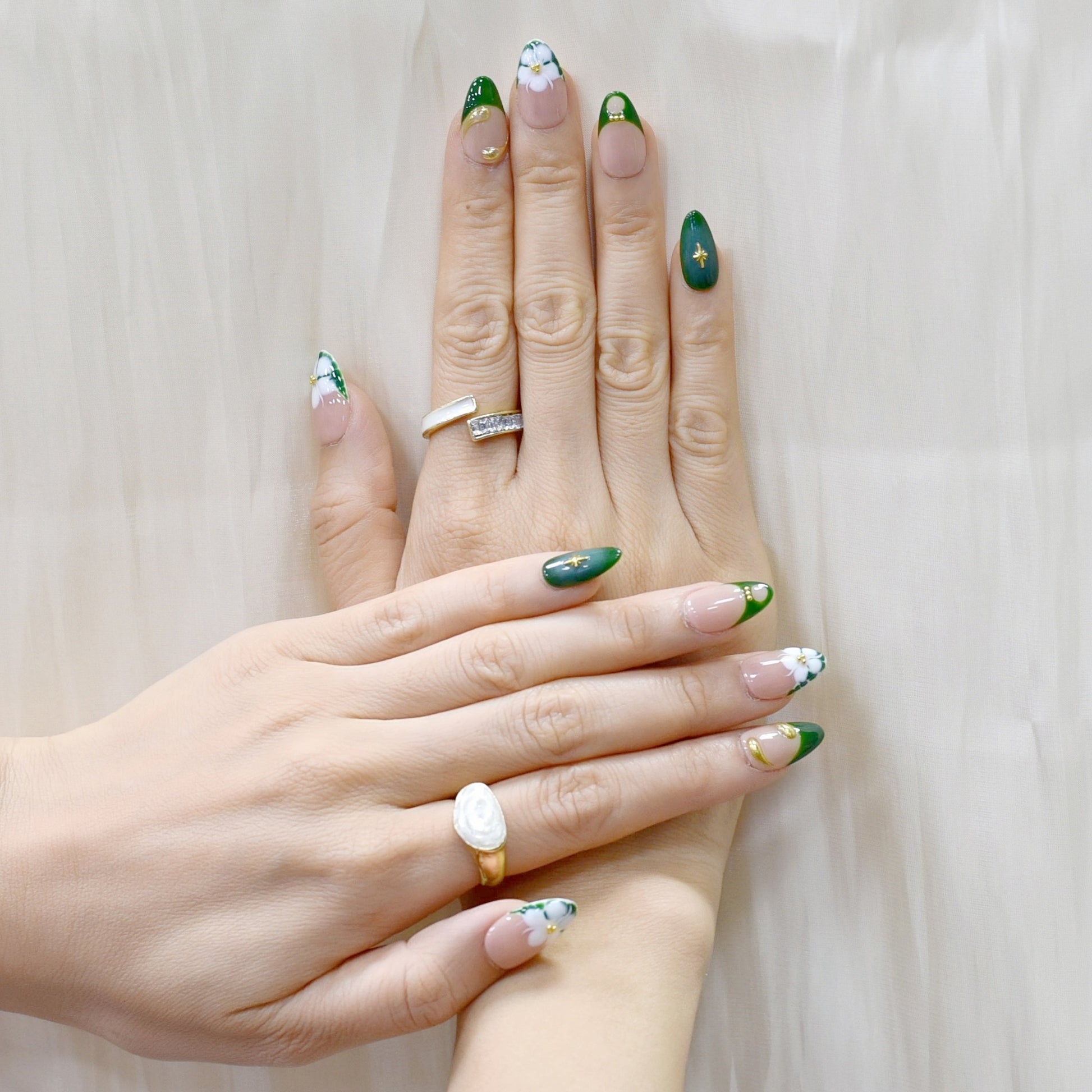 Press-on nails with emerald green French tips, white 3D blossoms, and gold swirl accents – Emerald Blossom.