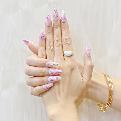 Pink press-on nails with rose art, silver heart charms, and ribbon detailing – Rosy Promise by You Are Angel.