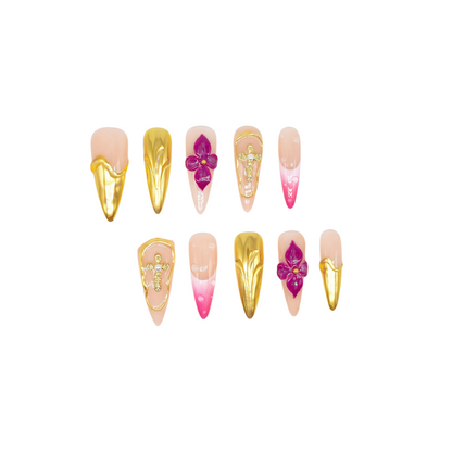 Royal Bloom press-on nails by You Are Angel with gold chrome accents, pink floral art, jeweled crosses, and long stiletto shape.