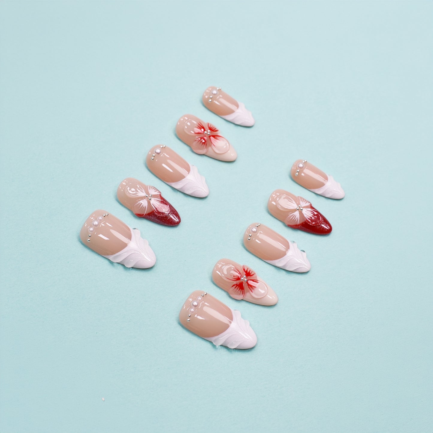 Red and white press on nails with 3D floral accents, leaf-shaped tips, and crystal embellishments – square shape from Heart & Heat Collection.