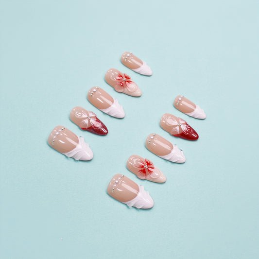 Red and white press on nails with 3D floral accents, leaf-shaped tips, and crystal embellishments – square shape from Heart & Heat Collection.