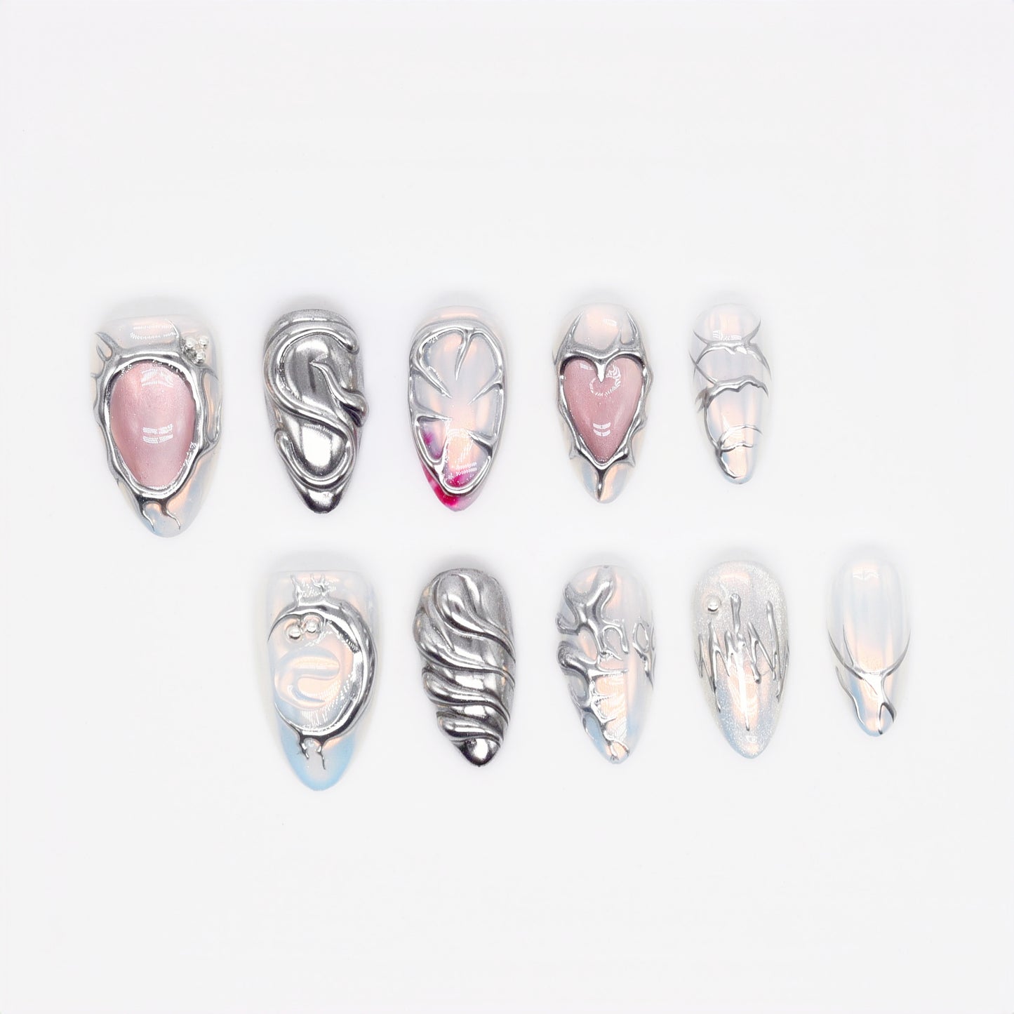 Medium Almond press-on nails with chrome textures, sculptural 3D hearts and swirls, and pearlescent nude base — Silver Luster Muse.
