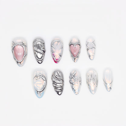 Medium Almond press-on nails with chrome textures, sculptural 3D hearts and swirls, and pearlescent nude base — Silver Luster Muse.