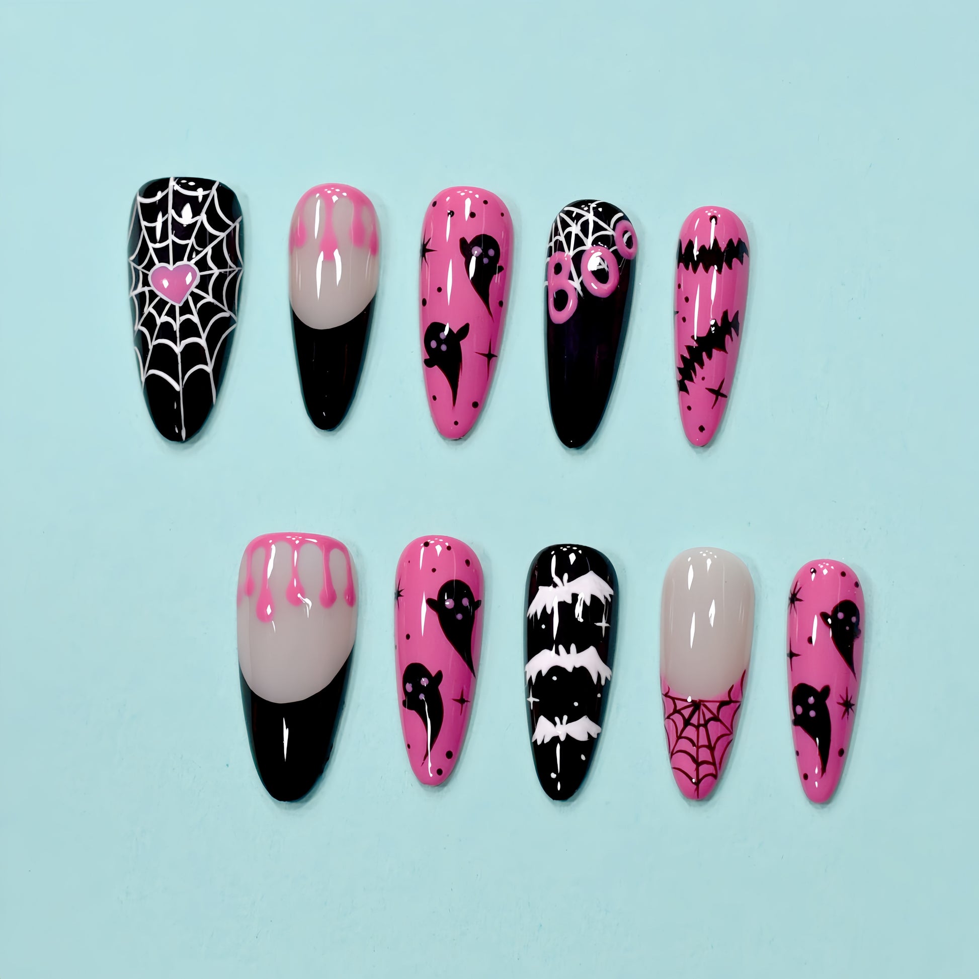 Halloween press-on nails with spider web, bats, ghosts, and dripping blood designs in black and pink.