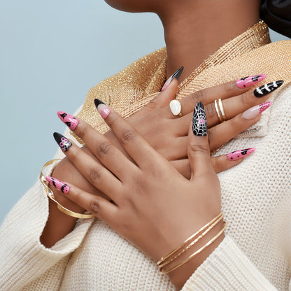 Halloween press-on nails with spider web, bats, ghosts, and dripping blood designs in black and pink.