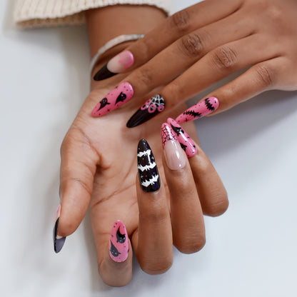 Halloween press-on nails with spider web, bats, ghosts, and dripping blood designs in black and pink.