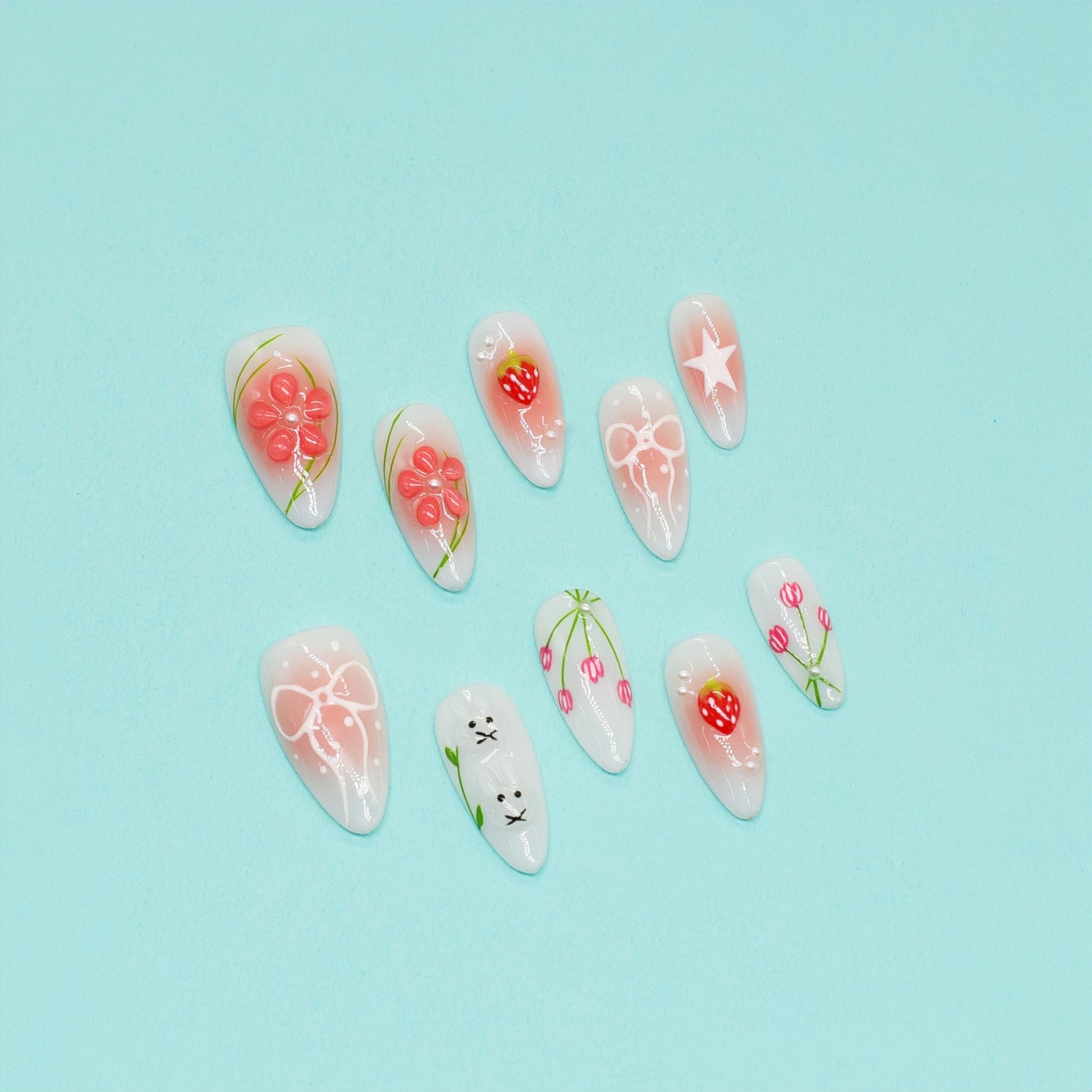 Handmade pink and white press-on nails with 3D bows, strawberry art, bunny design, and floral accents – Candy Bloom Collection