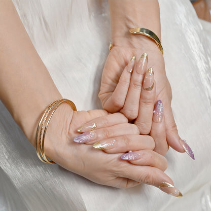 Sunset Pearl Bloom press-on nails in almond shape with peach-to-mauve ombré, golden swirls, and pearl accents – Tropical Bloom Collection