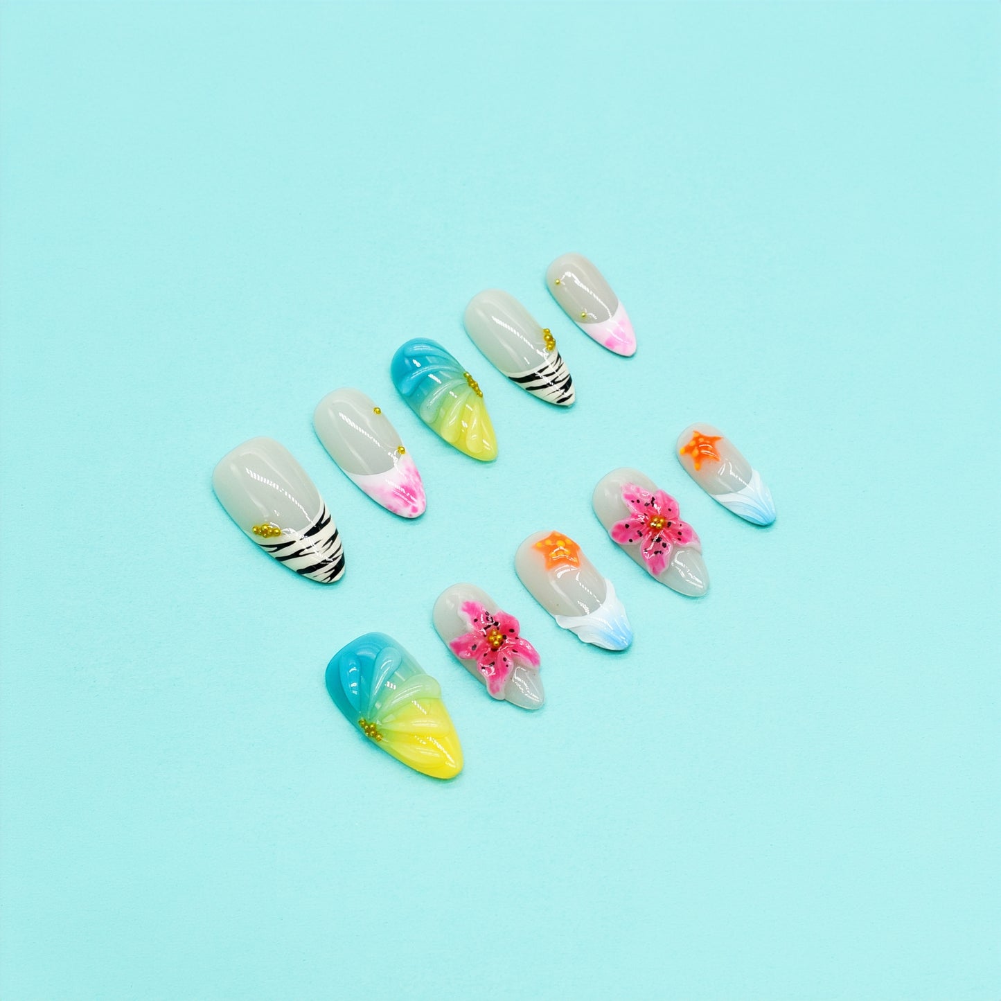 Medium almond tropical-themed press-on nails with zebra stripes, ombre seashell textures, 3D hibiscus flowers, and starfish accents.