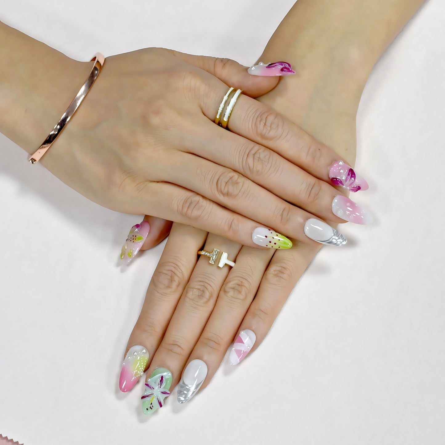 Tutti Frutti Bloom press-on nails featuring a colorful mix of pink, green, and purple with 3D flowers, jelly gradients, and pearl accents in almond shape.