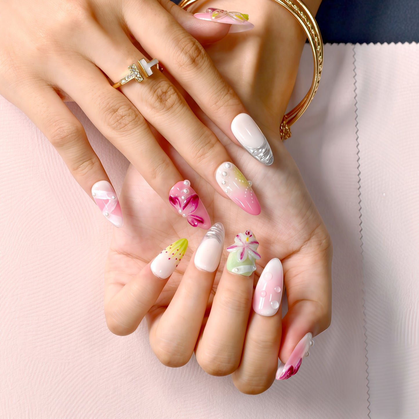 Tutti Frutti Bloom press-on nails featuring a colorful mix of pink, green, and purple with 3D flowers, jelly gradients, and pearl accents in almond shape.