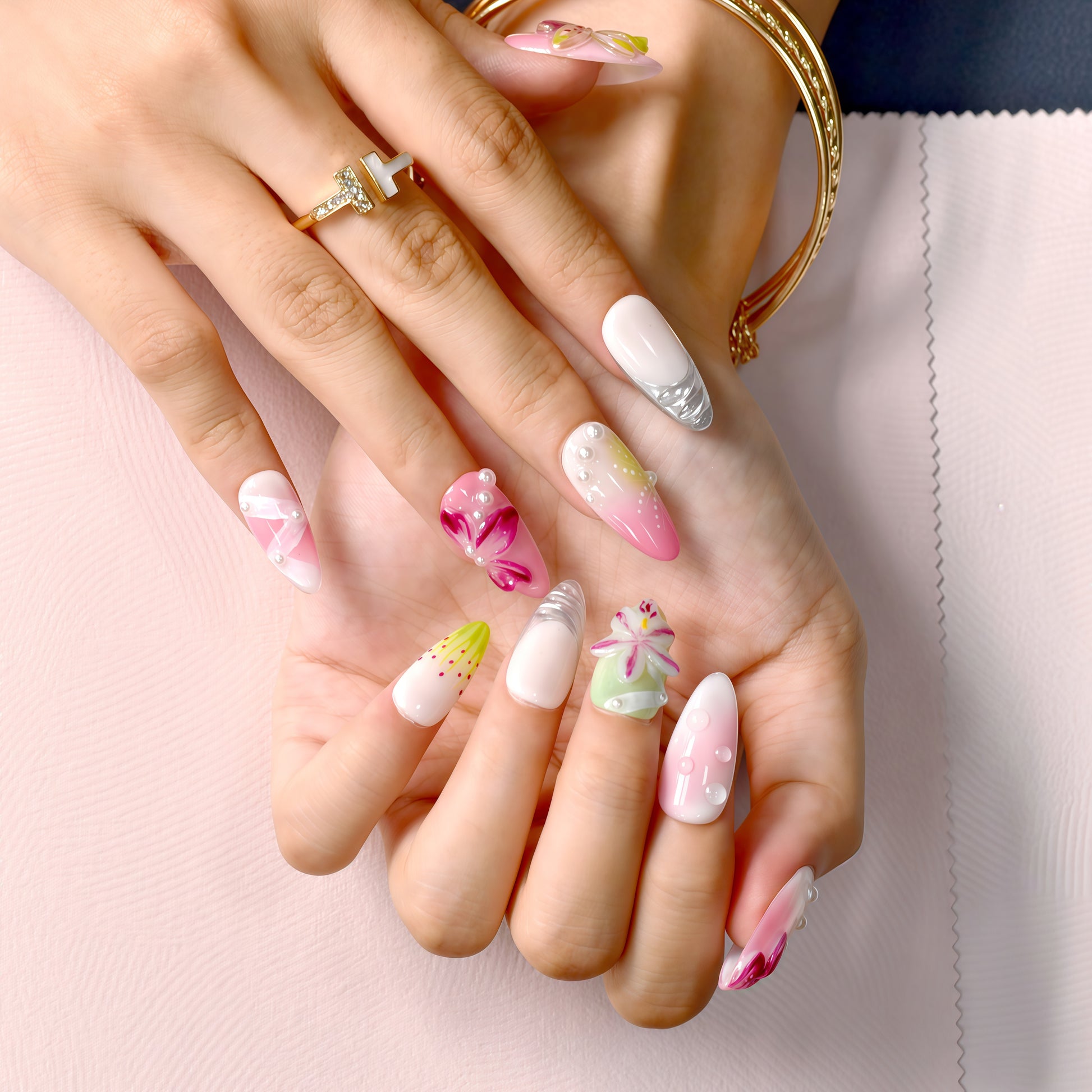 Tutti Frutti Bloom press-on nails featuring a colorful mix of pink, green, and purple with 3D flowers, jelly gradients, and pearl accents in almond shape.