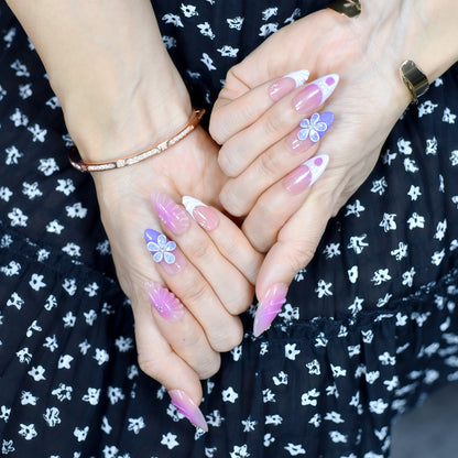 Almond-shaped press-on nails in pink-to-yellow gradient with gold beads and 3D flower accents – Sunset Bloom 