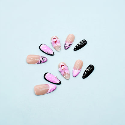 Medium Almond press-on nails in pink ombré with black zebra print, 3D orchid flowers, and rhinestone-studded accents.