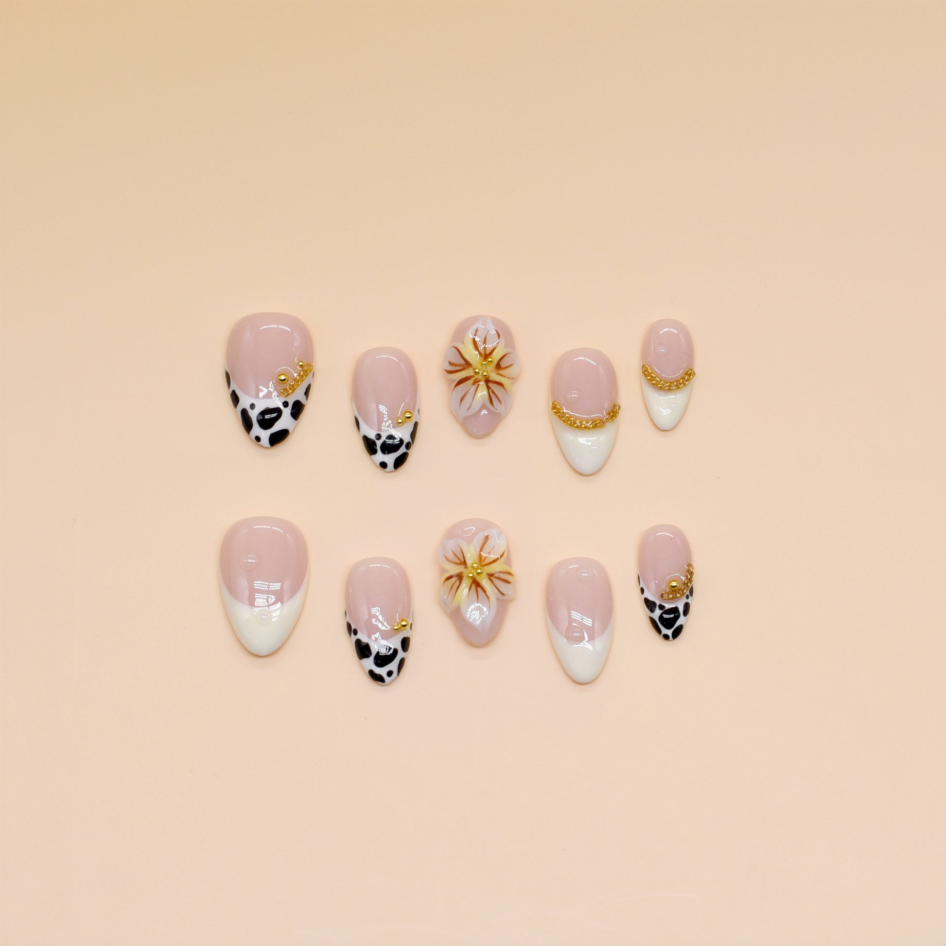Handmade press-on nails with black animal print, orange floral design, and nude French tips – Wild Bloom Elegance set.
