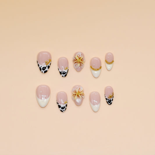 Handmade press-on nails with black animal print, orange floral design, and nude French tips – Wild Bloom Elegance set.