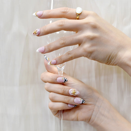Handmade press-on nails with black animal print, orange floral design, and nude French tips – Wild Bloom Elegance set.